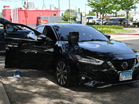 A vehicle is being damaged by bullet holes in the KFC parking lot. Three people are being shot in Chicago, Illinois, United States, on June...