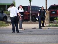 Chicago police and the crime scene unit are investigating the shooting and putting down evidence markers for shell casings, with over 80 evi...