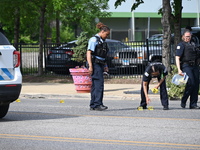 Chicago police and the crime scene unit are investigating the shooting and putting down evidence markers for shell casings, with over 80 evi...