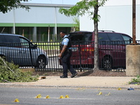 Chicago police and the crime scene unit are investigating the shooting and putting down evidence markers for shell casings, with over 80 evi...