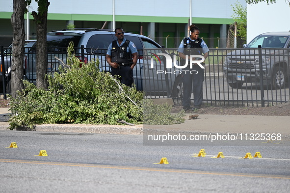 Chicago police and the crime scene unit are investigating the shooting and putting down evidence markers for shell casings, with over 80 evi...