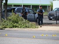 Chicago police and the crime scene unit are investigating the shooting and putting down evidence markers for shell casings, with over 80 evi...