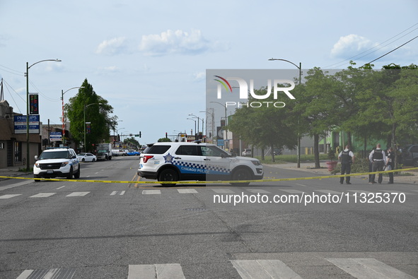 Chicago police and the crime scene unit are investigating the shooting and putting down evidence markers for shell casings, with over 80 evi...