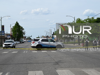 Chicago police and the crime scene unit are investigating the shooting and putting down evidence markers for shell casings, with over 80 evi...