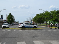 Chicago police and the crime scene unit are investigating the shooting and putting down evidence markers for shell casings, with over 80 evi...