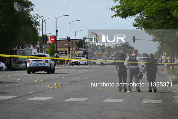 Chicago police and the crime scene unit are investigating the shooting and putting down evidence markers for shell casings, with over 80 evi...