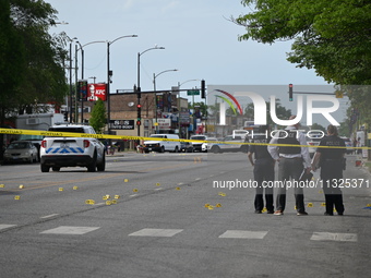 Chicago police and the crime scene unit are investigating the shooting and putting down evidence markers for shell casings, with over 80 evi...