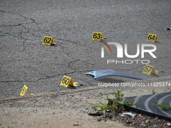 Evidence markers are showing where shell casings are located at the crime scene. Three people are being shot in Chicago, Illinois, United St...