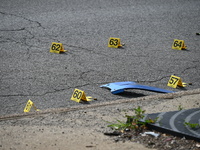 Evidence markers are showing where shell casings are located at the crime scene. Three people are being shot in Chicago, Illinois, United St...