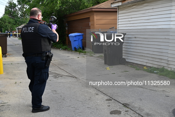 Chicago police are taking pictures of the crime scene. A 17-year-old male victim is shot multiple times and is in critical condition in Chic...