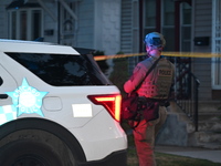 The Chicago Police SWAT Team is arriving at residences to search for suspects involved in the shooting of a 67-year-old male food vendor in...