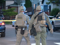 The Chicago Police SWAT Team is arriving at residences to search for suspects involved in the shooting of a 67-year-old male food vendor in...