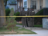 The Chicago Police SWAT Team is arriving at residences to search for suspects involved in the shooting of a 67-year-old male food vendor in...