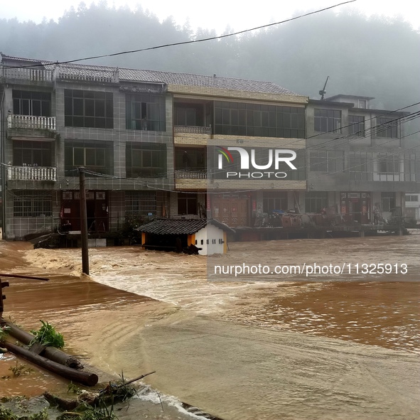 The flood damage is occurring in Gaozhai village, Qiandongnan County, Guizhou province, China, on the morning of June 12, 2024. 