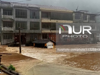 The flood damage is occurring in Gaozhai village, Qiandongnan County, Guizhou province, China, on the morning of June 12, 2024. (