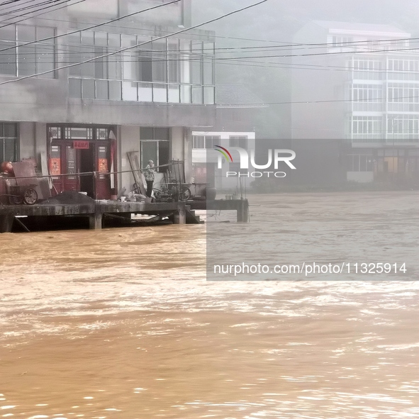 The flood damage is occurring in Gaozhai village, Qiandongnan County, Guizhou province, China, on the morning of June 12, 2024. 