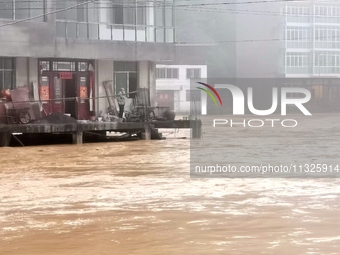 The flood damage is occurring in Gaozhai village, Qiandongnan County, Guizhou province, China, on the morning of June 12, 2024. (