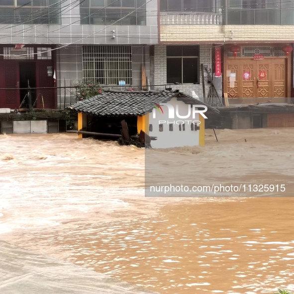 The flood damage is occurring in Gaozhai village, Qiandongnan County, Guizhou province, China, on the morning of June 12, 2024. 