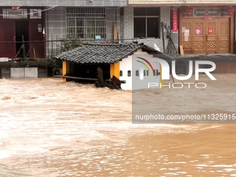 The flood damage is occurring in Gaozhai village, Qiandongnan County, Guizhou province, China, on the morning of June 12, 2024. (