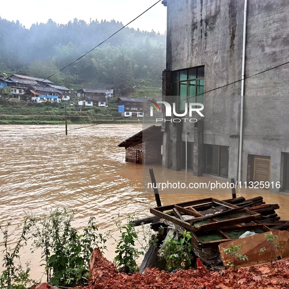 The flood damage is occurring in Gaozhai village, Qiandongnan County, Guizhou province, China, on the morning of June 12, 2024. 