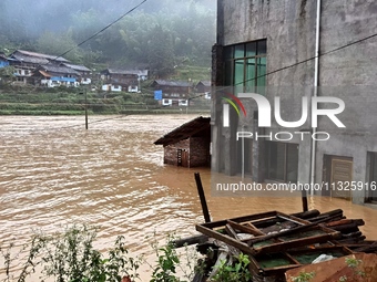 The flood damage is occurring in Gaozhai village, Qiandongnan County, Guizhou province, China, on the morning of June 12, 2024. (