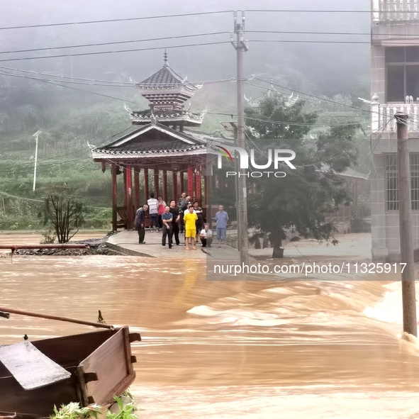 The flood damage is occurring in Gaozhai village, Qiandongnan County, Guizhou province, China, on the morning of June 12, 2024. 