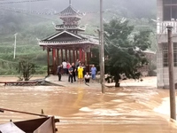 The flood damage is occurring in Gaozhai village, Qiandongnan County, Guizhou province, China, on the morning of June 12, 2024. (