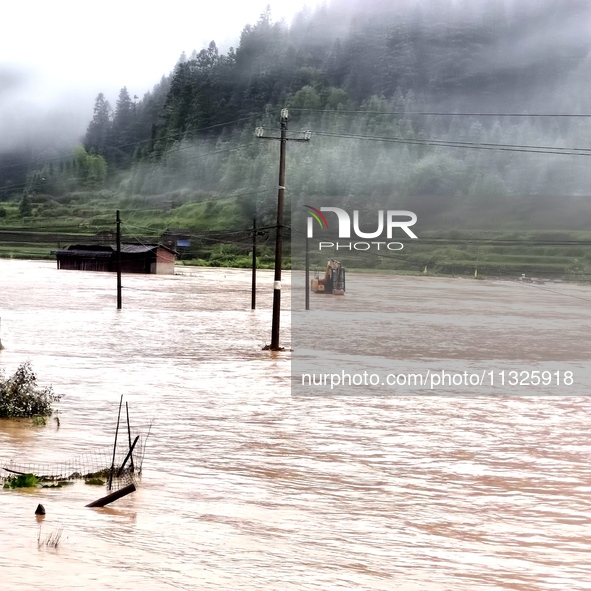 The flood damage is occurring in Gaozhai village, Qiandongnan County, Guizhou province, China, on the morning of June 12, 2024. 