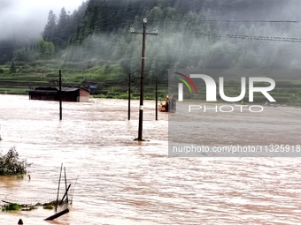 The flood damage is occurring in Gaozhai village, Qiandongnan County, Guizhou province, China, on the morning of June 12, 2024. (