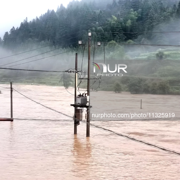 The flood damage is occurring in Gaozhai village, Qiandongnan County, Guizhou province, China, on the morning of June 12, 2024. 