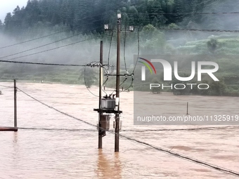 The flood damage is occurring in Gaozhai village, Qiandongnan County, Guizhou province, China, on the morning of June 12, 2024. (