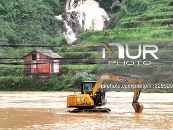 The flood damage is occurring in Gaozhai village, Qiandongnan County, Guizhou province, China, on the morning of June 12, 2024. (