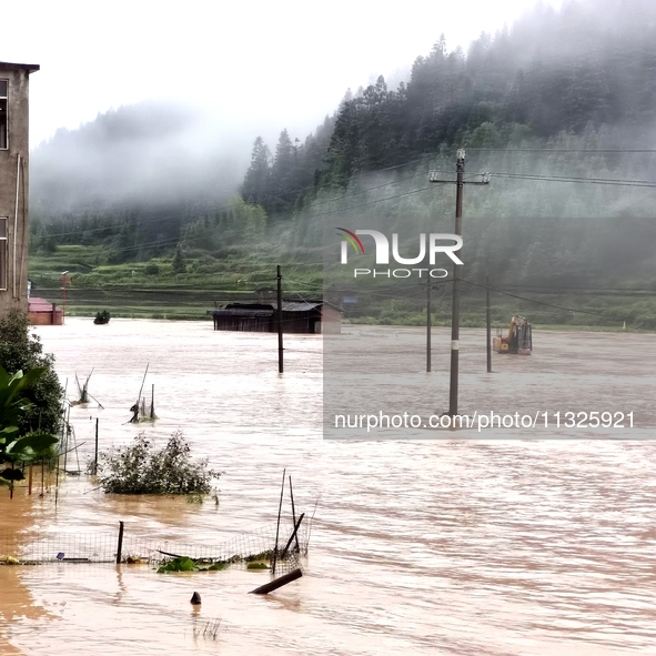 The flood damage is occurring in Gaozhai village, Qiandongnan County, Guizhou province, China, on the morning of June 12, 2024. 