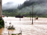 The flood damage is occurring in Gaozhai village, Qiandongnan County, Guizhou province, China, on the morning of June 12, 2024. (