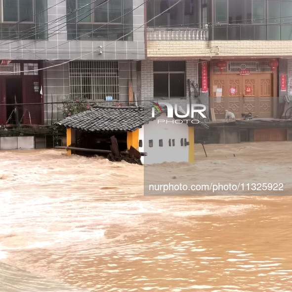 The flood damage is occurring in Gaozhai village, Qiandongnan County, Guizhou province, China, on the morning of June 12, 2024. 