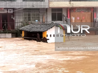 The flood damage is occurring in Gaozhai village, Qiandongnan County, Guizhou province, China, on the morning of June 12, 2024. (