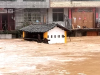 The flood damage is occurring in Gaozhai village, Qiandongnan County, Guizhou province, China, on the morning of June 12, 2024. (