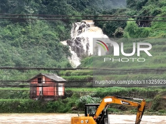 The flood damage is occurring in Gaozhai village, Qiandongnan County, Guizhou province, China, on the morning of June 12, 2024. (