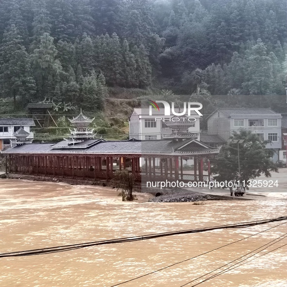 The flood damage is occurring in Gaozhai village, Qiandongnan County, Guizhou province, China, on the morning of June 12, 2024. 