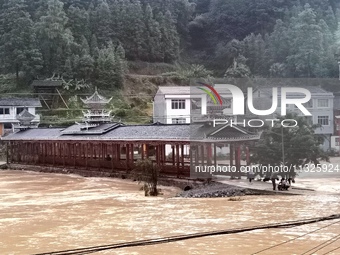 The flood damage is occurring in Gaozhai village, Qiandongnan County, Guizhou province, China, on the morning of June 12, 2024. (