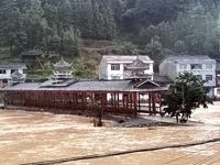 The flood damage is occurring in Gaozhai village, Qiandongnan County, Guizhou province, China, on the morning of June 12, 2024. (