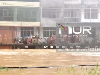 The flood damage is occurring in Gaozhai village, Qiandongnan County, Guizhou province, China, on the morning of June 12, 2024. (