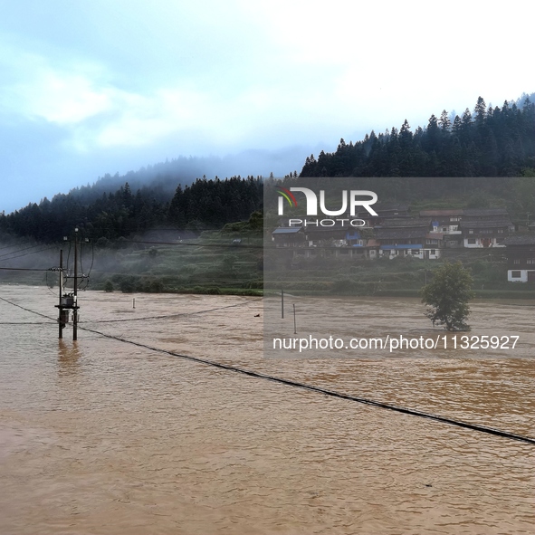 The flood damage is occurring in Gaozhai village, Qiandongnan County, Guizhou province, China, on the morning of June 12, 2024. 