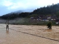 The flood damage is occurring in Gaozhai village, Qiandongnan County, Guizhou province, China, on the morning of June 12, 2024. (