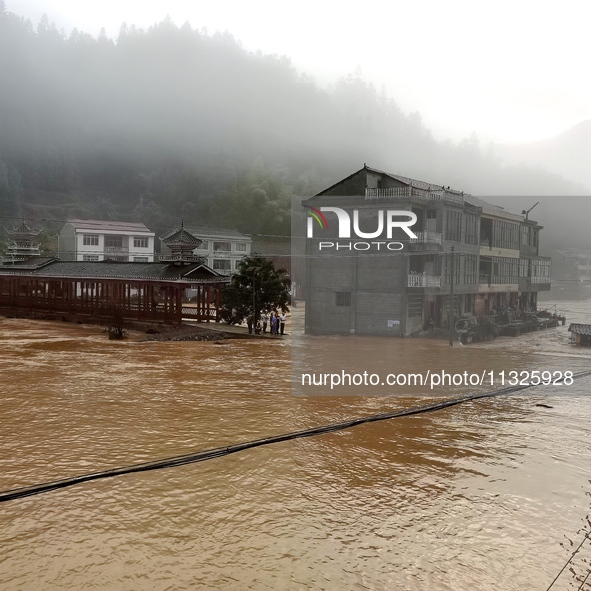 The flood damage is occurring in Gaozhai village, Qiandongnan County, Guizhou province, China, on the morning of June 12, 2024. 