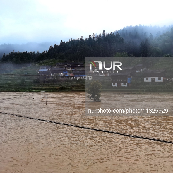 The flood damage is occurring in Gaozhai village, Qiandongnan County, Guizhou province, China, on the morning of June 12, 2024. 