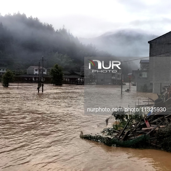 The flood damage is occurring in Gaozhai village, Qiandongnan County, Guizhou province, China, on the morning of June 12, 2024. 