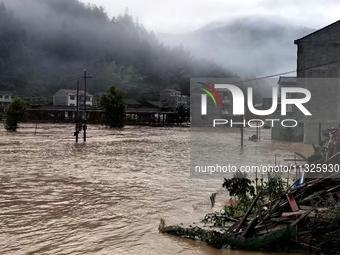 The flood damage is occurring in Gaozhai village, Qiandongnan County, Guizhou province, China, on the morning of June 12, 2024. (