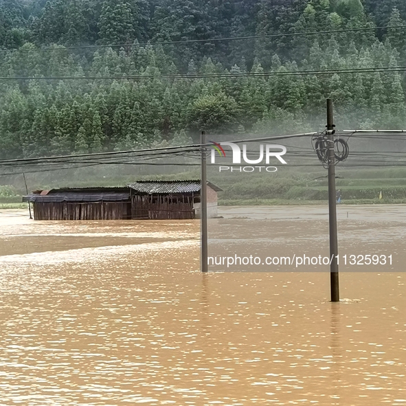 The flood damage is occurring in Gaozhai village, Qiandongnan County, Guizhou province, China, on the morning of June 12, 2024. 