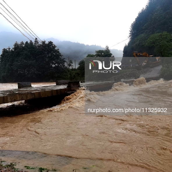 The flood damage is occurring in Gaozhai village, Qiandongnan County, Guizhou province, China, on the morning of June 12, 2024. 